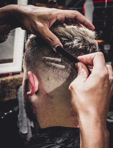 man-having-a-hair-cut-inside-shop-2809652