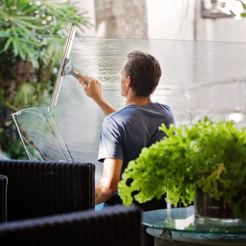 man-in-gray-shirt-cleaning-clear-glass-wall-near-sofa-713297 man-in-gray-shirt-cleaning-clear-glass-wall-near-sofa-713297